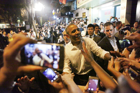 Obama is surrounded by local people