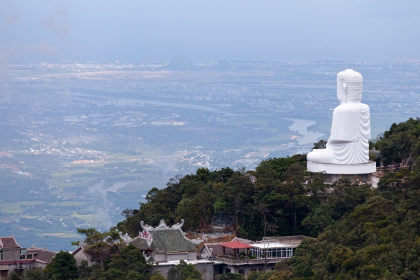 Giant Buddha statue on Ba Na Hills facing Da Nang city below
